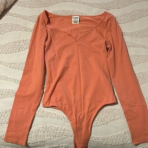 Pink xs long sleeve bodysuit (never worn)